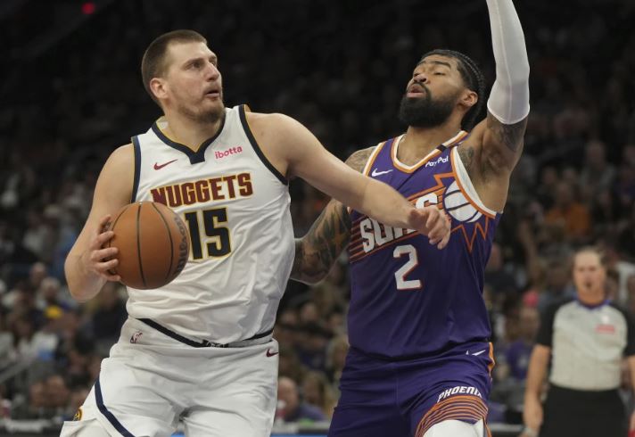 El serbio Nikola Jokic, de los Nuggets de Denver, avanza frente a Nick Richards, de los Suns de Phoenix, el sábado 8 de febrero de 2025 (AP Foto/Rick Scuteri)